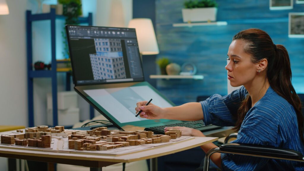 woman disability touch screen design construction office architect wheelchair analyzing model construction computer table creating plan project development